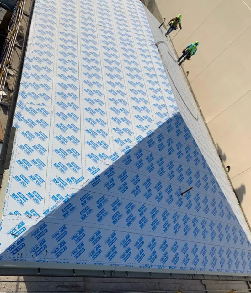 Professional roofers installing underlayment on a metal roof in Strasburg